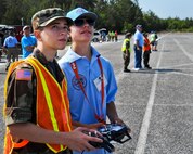 Cody Powell, the 13-year-old son of Maj. Jeff Powell, the 919th Maintenance Operations Flight commander, helps a member of Eglin's Civil Air Patrol learn to fly an radio controlled aircraft April 27. Cody has won all but one of his 15 RC aircraft competitions since he and his father joined the hobby two years ago. (Courtesy photo)