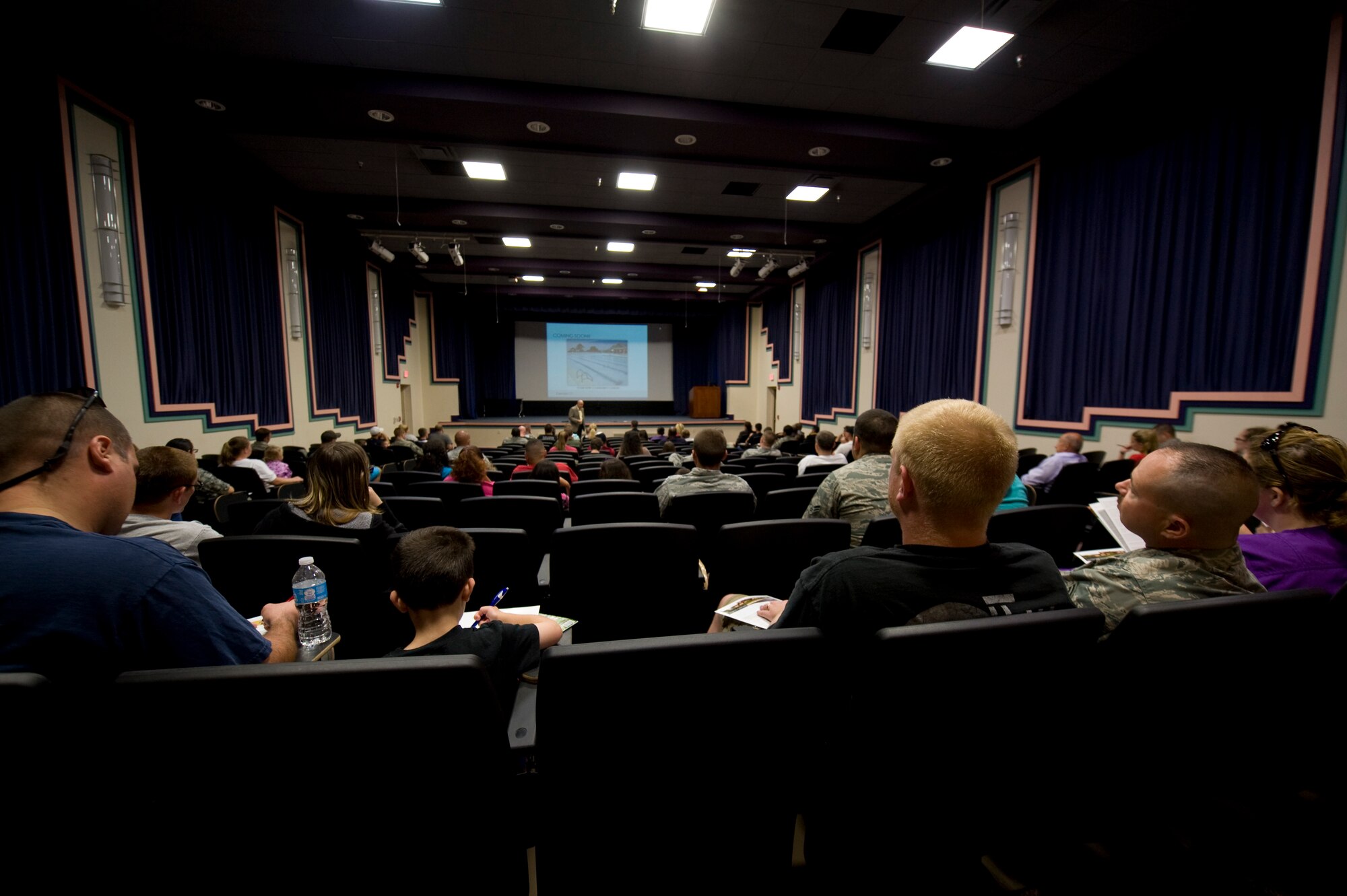 Base housing residents attend a town hall meeting regarding the privatization of Hurlburt military housing at the King Auditorium on Hurlburt Field Fla., May 6, 2013. Residents participated in an open forum question and answer session with the representatives for Corvias Military Living. (U.S. Air Force Photo/Staff Sgt. John Bainter)