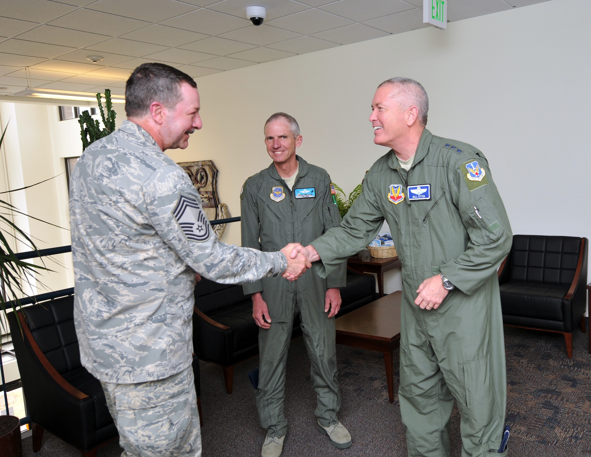U.S. Air Force Chief Master Sgt. Andy Huneycutt, loadmaster for the 156th Airlift Squadron, North Carolina Air National Guard, meets Lt. Gen. William A. Etter, 1st Air Force commander and Col. Dennis Grunstad, assistant adjutant general-Air, Wyoming Air National Guard, during the annual Modular Airborne Fire Fighting System training for certification. Chief Huneycutt is one of two survivors of MAFFS 7, the 145th Airlift Wing C-130 Hercules aircraft that crashed while fighting forest fires in South Dakota, July 1, 2012. The 153rd Airlift Wing, Wyoming Air National Guard, hosts the 2013 MAFFS training at the Cheyenne Regional Airport, Cheyenne, Wyo., May 7, 2013. (U.S. Air National Guard photo by Tech. Sgt. Patricia Findley/Released)