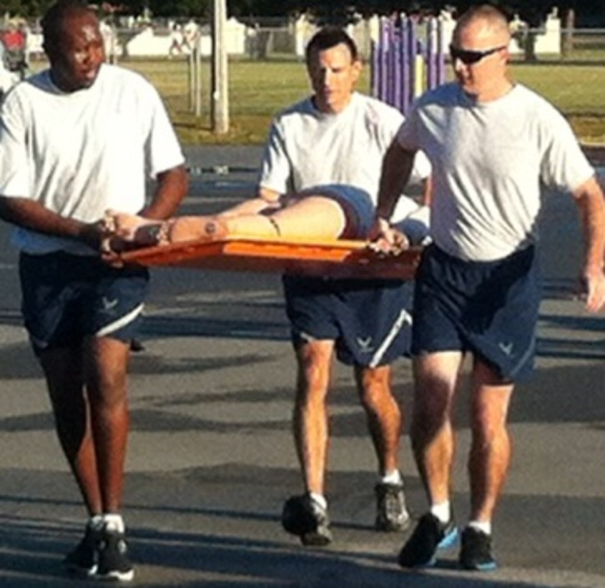325th Medical Group members carry a medical manikin as part of the medical olmpics. The  group celebrated Nurses and Medical Technician Week with a series of events. In any given month, about 4,100 patients are seen at the clinic on base.(Courtesy Photo)