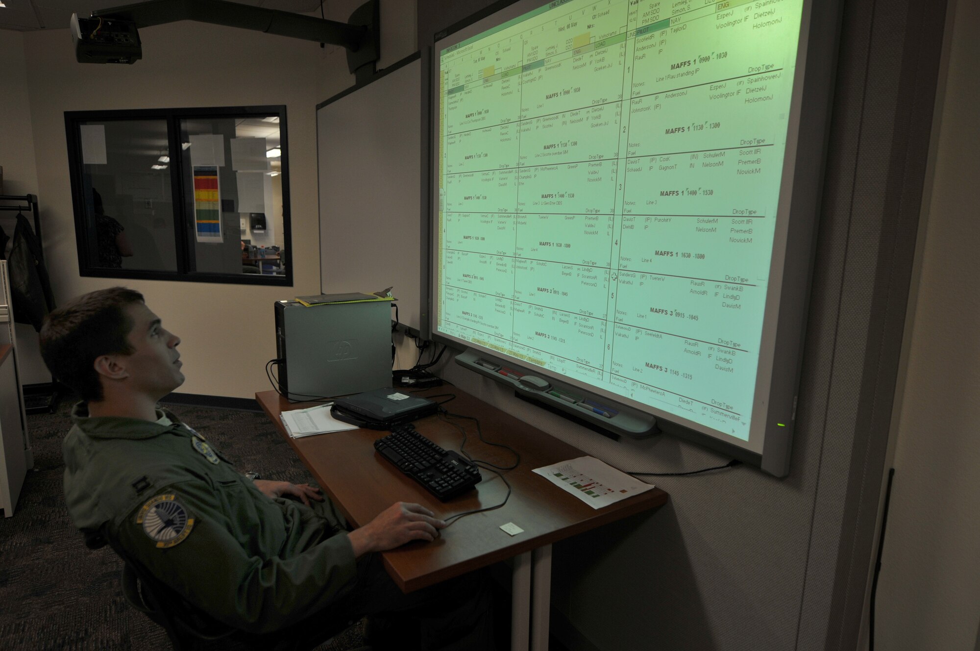 U.S. Air Force Capt. Chris Valine, pilot for the 30th Airlift Squadron, Wyoming Air National Guard runs the scheduling board for flight operations during the Modular Airborne Fire Fighting System annual training for certification. The 145th Airlift Wing North Carolina Air National Guard and 153rd Airlift Wing, Wyoming Air National Guard trained together at the Cheyenne Regional Airport, Cheyenne, Wyo., May 7, 2013. (U.S. Air National Guard photo by Tech. Sgt. Patricia Findley/Released)