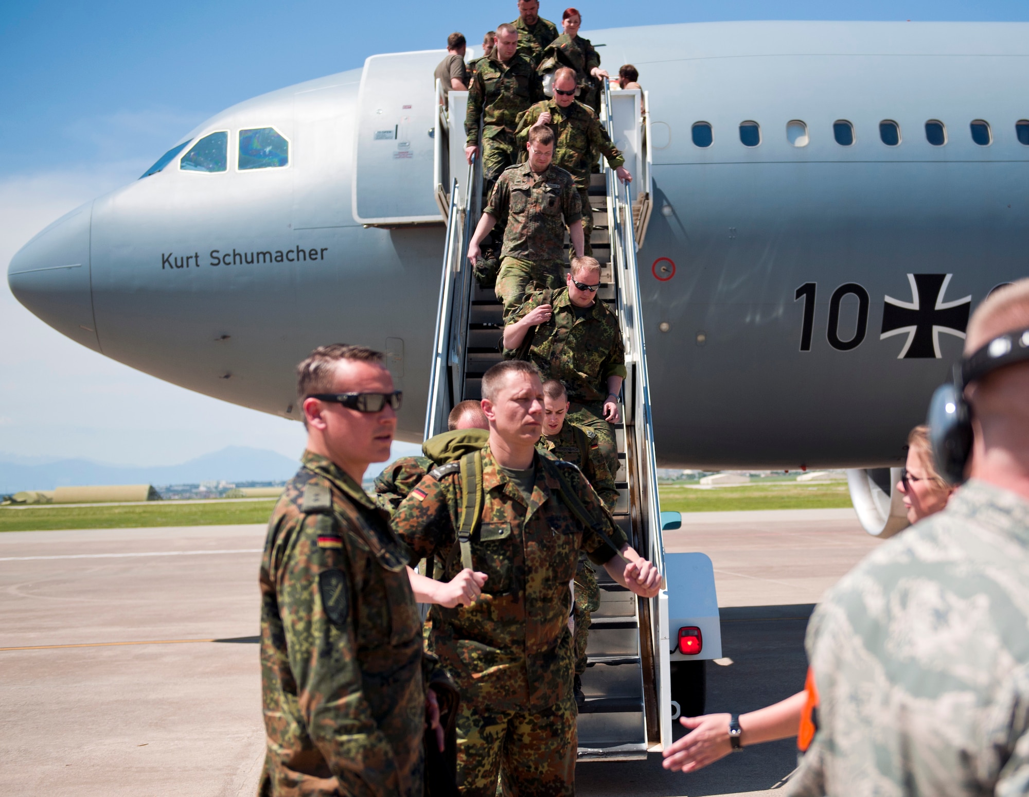 Airman 1st Class Trevor Caldwell, 728th Air Mobility Squadron air freight journeyman, directs German soldiers to the 728th AMS passenger terminal May 1, 2013, at Incirlik Air Base, Turkey. German personnel arrived at Incirlik as part of their deployment turnover to support the NATO mission of deterrence of hostile actions along the Turkish-Syrian border. (U.S. Air Force photo by Senior Airman Daniel Phelps/Released)