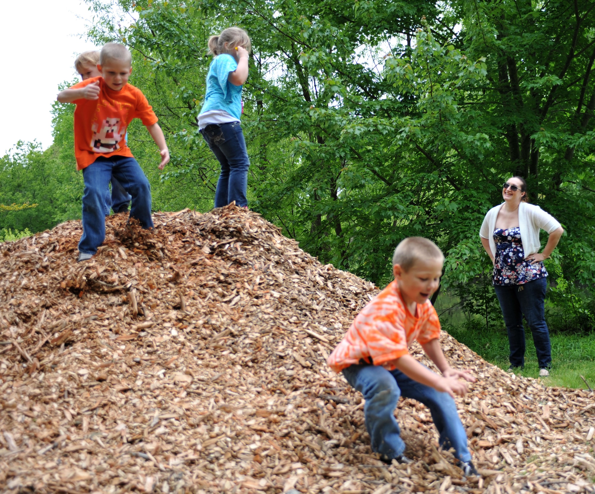 Staff Sgt. Heather Seeger, 1st Maintenance Operations Squadron noncommissioned officer in charge of production analysis, watches four of her six her children play during a family trip to Bluebird Gap Farm in Hampton, Va., May 5, 2013. Pictured from left, Jake, Kevin, Angel and Nick all try to help their mother while their father is deployed.   (U.S. Air Force photo by Staff Sgt. Katie Gar Ward/Released)