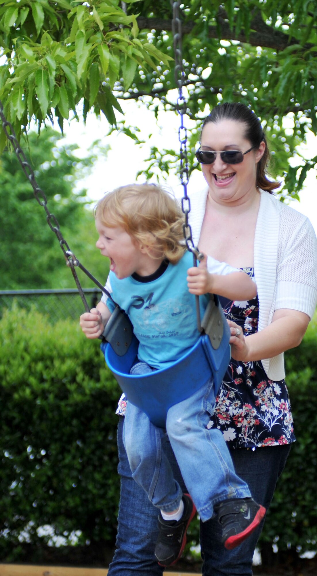 Staff Sgt. Heather Seeger, 1st Maintenance Operations Squadron noncommissioned officer in charge of production analysis, plays with her son Jake during a family trip to Bluebird Gap Farm in Hampton, Va., May 5, 2013. Seeger relies on a strong support system to help keep her family of six children close while her husband is deployed. (U.S. Air Force photo by Staff Sgt. Katie Gar Ward/Released)