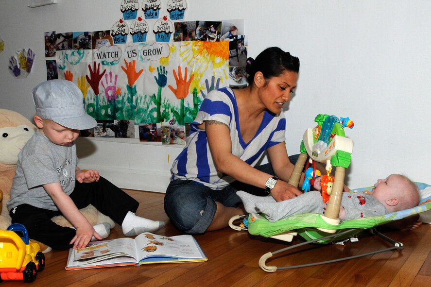 HANSCOM AIR FORCE BASE, Mass. -- Family Child Care provider Jacquelyn Duarte-Smith sits with Keith (left) and Jack (right) Paynter on May 2 during play time at her house where she cares for children. Hanscom is celebrating Provider Appreciation Day May 10 by thanking all child care providers from FCC, the Child Development Center and School Age program. (U.S. Air Force photo by Linda LaBonte Britt)