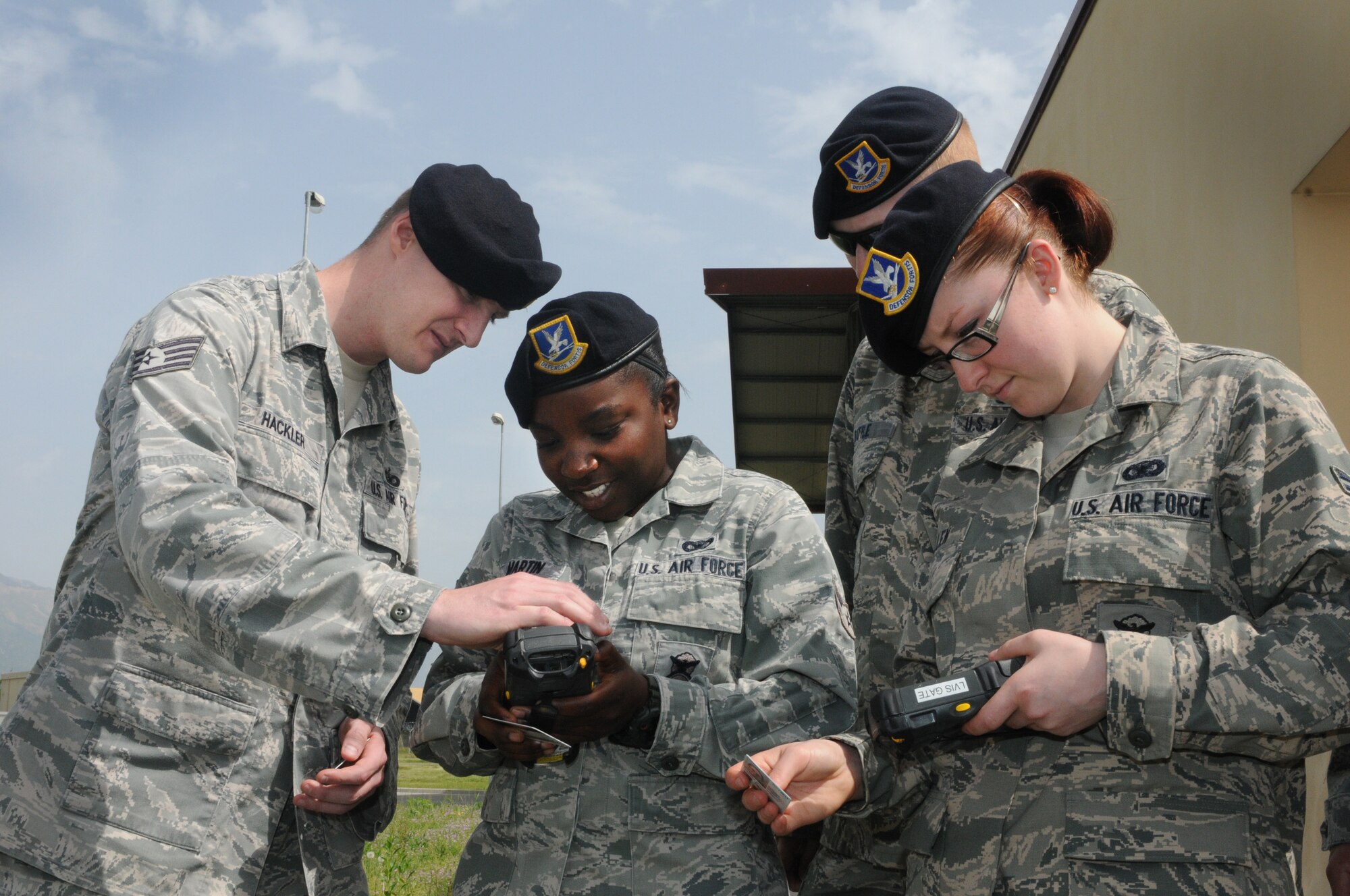 31st Security Forces Airmen use new Installation Access Control System handheld devices to scan and validate ID cards May 2, 2013, at Aviano Air Base, Italy. The Installation Access Control System provides the capability to maintain an automated historical record of personnel who have accessed U.S. Air Forces in Europe installations, receive immediate notification when a barred individual attempts to enter the installation, as well as support Force Protection Condition measures related to installation access control. (U.S. Air Force photo/Staff Sgt. Justin Weaver) 