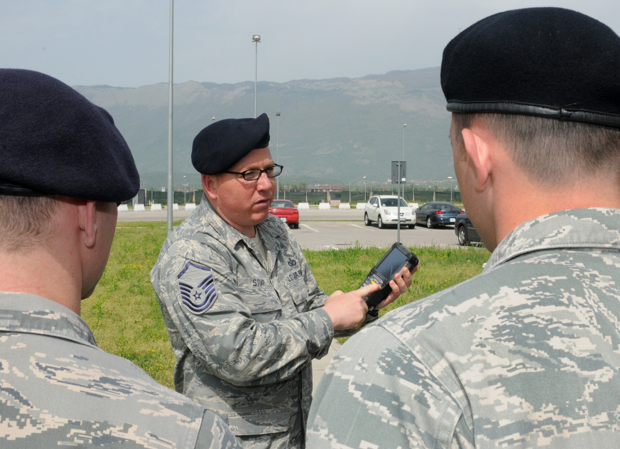 Master Sgt. Jeffrey Stuart, 31st Security Forces NCO in charge of installation security, trains security forces Airmen on the features of a new handheld device used to scan and validate ID cards at installation control points May 2, 2013, at Aviano Air Base, Italy. The Installation Access Control System provides the capability to maintain an automated historical record of personnel who have accessed U.S. Air Forces in Europe installations, receive immediate notification when a barred individual attempts to enter the installation, as well as support Force Protection Condition measures related to installation access control. (U.S. Air Force photo/Staff Sgt. Justin Weaver) 