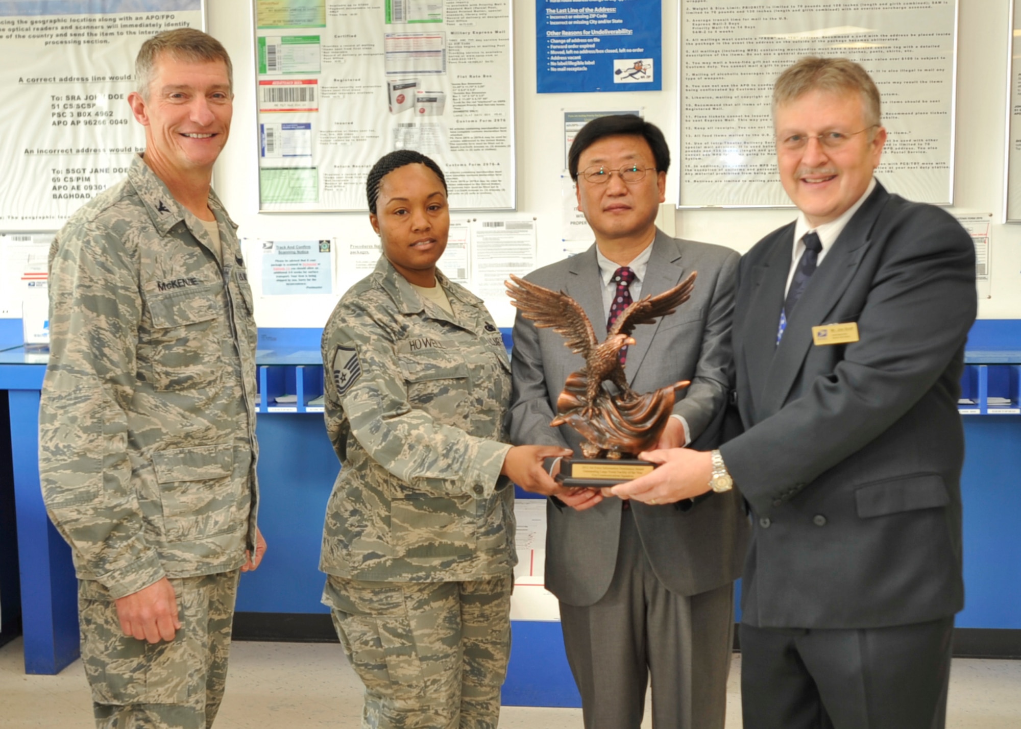 Col. Patrick McKenzie, 51st Fighter Wing commander, and leadership of the Osan Post Office pose for a photo with their award for winning Best Post Office in the Air Force for 2012 at Osan Air Base, Republic of Korea, May 8, 2013. This award marks the third time the Osan Post Office has won Best Post Office in the Air Force Award since 1993. Osan’s 35-member postal team delivered more than four million pounds of mail to more than 11,000 U.S. Forces of Korea personnel in 2012. (U.S. Air Force photo/Senior Airman Siuta B. Ika)