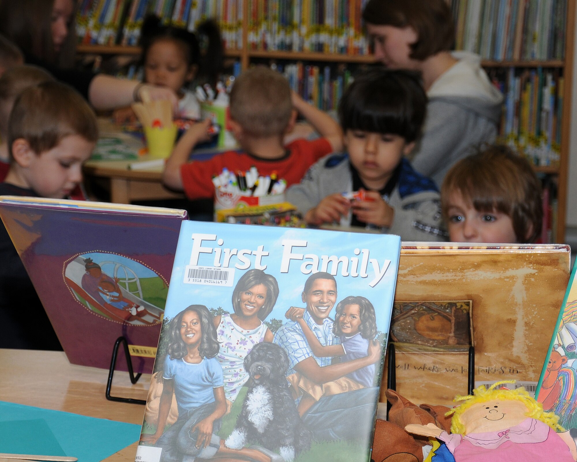 Children of service members enjoy activities and stories in the library May 1, 2013, at RAF Mildenhall, England. Children make up a large percentage of the users of the library. (U.S. Air Force photo by Gina Randall/Released)