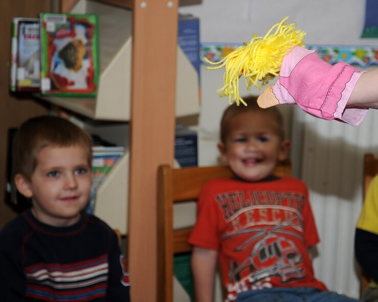 Jillian Mealy from Toledo, Ohio., uses a glove puppet to make stories come to life for children during story time May 1, 2013, at the library on RAF Mildenhall, England. The library offers many events, large and small, including story time, held each Wednesday. (U.S. Air Force photo by Gina Randall/Released)