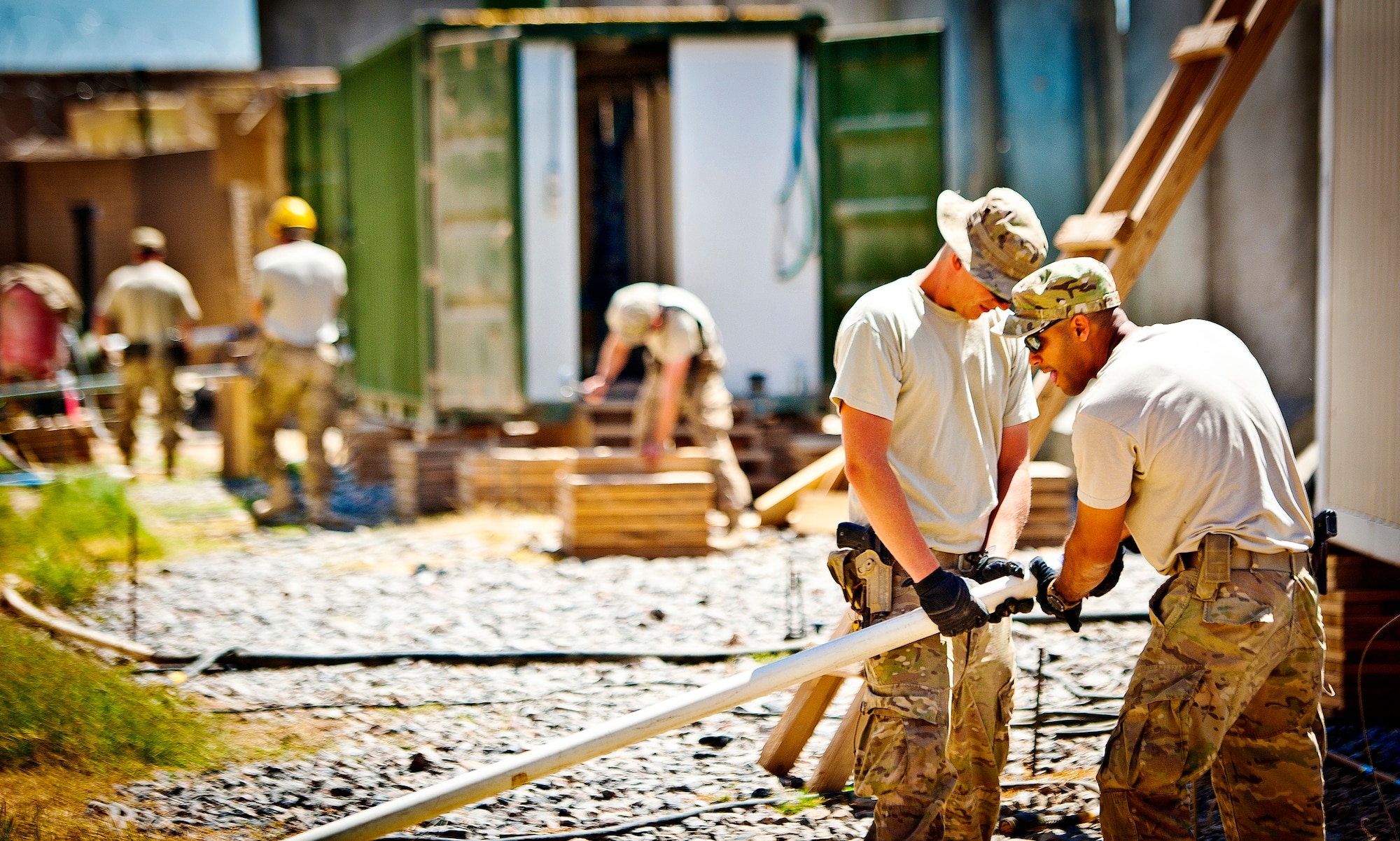 Members of the 577th Expeditionary Prime Base Engineer Emergency Force Squadron Consolidated-Small Maintenance and Repair Team, work on installing nearly 200-feet of new polyvinyl chloride pipe at Combat Outpost Azimijan Kariz, Afghanistan, April 30, 2013. The C-SMART made their second of two visits to COP AJK to repair a sewage line, repair an electrical box that runs a well and pump, as well as check for any other issues that could be potentially hazardous to the residents on the compound. (U.S. Air Force photo/Senior Airman Scott Saldukas)