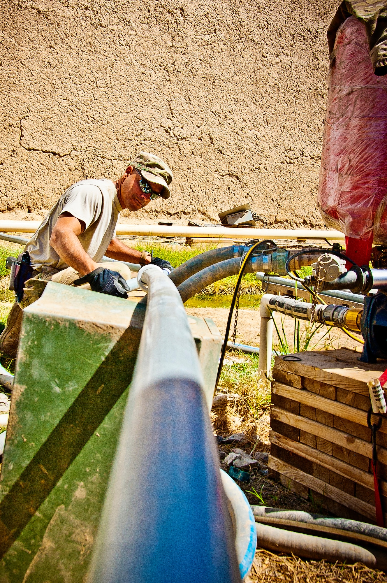 Staff Sgt. Alexis Lopez, 577th Expeditionary Prime Base Engineer Emergency Force Squadron Consolidated-Small Maintenance and Repair Team Water and Fuels System Maintenance craftsman, ensures a new 10-foot piece of white polyvinyl chloride pipe is stable at Combat Outpost Azimijan Kariz, Afghanistan, April 30, 2013. Each C-SMART consists of a plumbing, electrical, heating, ventilation and air conditioning, structural and power pro specialist. (U.S. Air Force photo/Senior Airman Scott Saldukas)