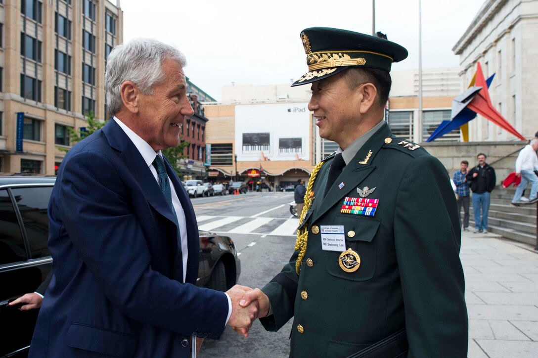 U.S. Defense Secretary Chuck Hagel, left, greets South Korean Maj. Gen. Lee Seo Young, South Korean defense attache, during the 60th anniversary gala honoring the U.S.-South Korea alliance at the National Portrait Gallery in Washington, D.C., May 7, 2013. Before the event, Hagel met with South Korean President Park Geun-hye for a bilateral discussion.
