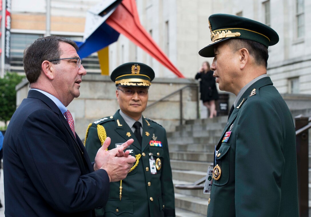 U.S. Deputy Defense Secretary Ash Carter, left, speaks with South Korean Maj. Gen. Lee Seo Young, right, South Korean defense attache, before the 60th anniversary gala honoring the U.S.-South Korea alliance at the National Portrait Gallery in Washington, D.C., May 7, 2013.