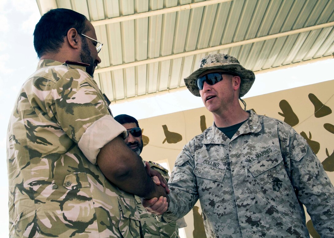 U.S. Marine Corps. Lt. Col. Kevin Collins, right, speaks with members of the Qatar Emiri Land Forces Al Galail, Qatar,  April 29, 2013. Eagle Resolve is an annual multilateral exercise designed to enhance regional cooperative defense efforts in the Gulf Cooperation Council nations and U.S. Central Command. Collins is the commander of Combat Logistics Battalion 26, 26th Marine Expeditionary Unit.
