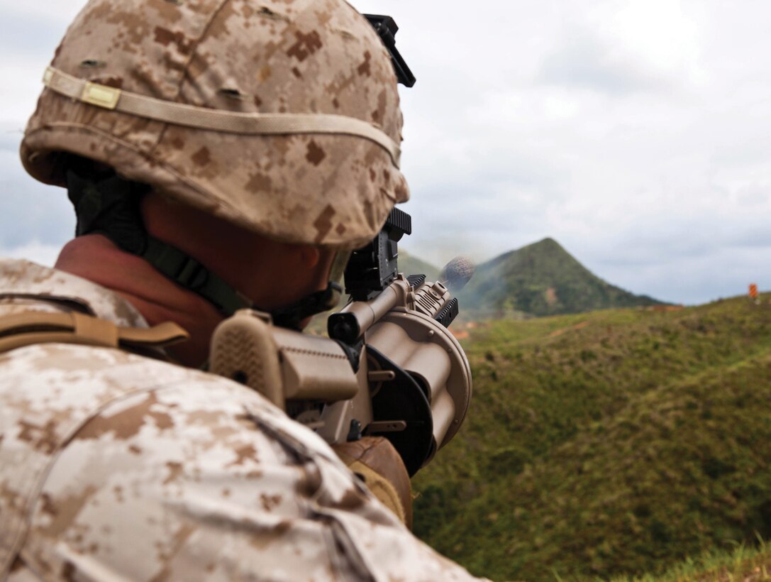 Lance Cpl. Jesse A. Kessler fires the M32 semiautomatic grenade launcher during individual weapons drills at Range 2 on Camp Hansen April 29. Kessler is a rifleman with 3rd Battalion, 6th Marine Regiment, which is currently assigned to 4th Marine Regiment, 3rd Marine Division, III Marine Expeditionary Force, under the unit deployment program.