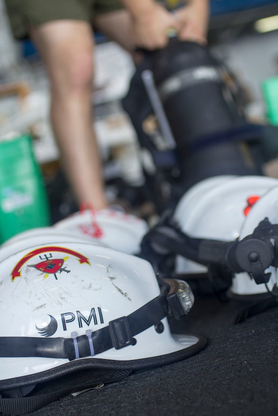 Chemical, biological, radiological and nuclear defense specialist U.S. Marines assigned to the 26th Marine Expeditionary Unit (MEU), conduct a confined space search and rescue in a hazardous environment exercise, in the hangar bay of the USS Kearsarge (LHD 3), while underway, May 8, 2013. The 26th MEU is deployed to the 5th Fleet area of operations aboard the Kearsarge Amphibious Ready Group. The 26th MEU operates continuously across the globe, providing the president and unified combatant commanders with a forward-deployed, sea-based quick reaction force. The MEU is a Marine Air-Ground Task Force capable of conducting amphibious operations, crisis response and limited contingency operations. (U.S. Marine Corps photograph by Cpl. Kyle N. Runnels/Released)