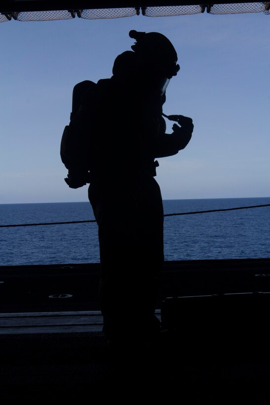 A chemical, biological, radiological and nuclear defense specialist U.S. Marine assigned to the 26th Marine Expeditionary Unit (MEU), checks his air gauge before conducting a confined space search and rescue in a hazardous environment exercise, in the hangar bay of the USS Kearsarge (LHD 3), while underway, May 8, 2013. The 26th MEU is deployed to the 5th Fleet area of operations aboard the Kearsarge Amphibious Ready Group. The 26th MEU operates continuously across the globe, providing the president and unified combatant commanders with a forward-deployed, sea-based quick reaction force. The MEU is a Marine Air-Ground Task Force capable of conducting amphibious operations, crisis response and limited contingency operations. (U.S. Marine Corps photograph by Cpl. Kyle N. Runnels/Released)