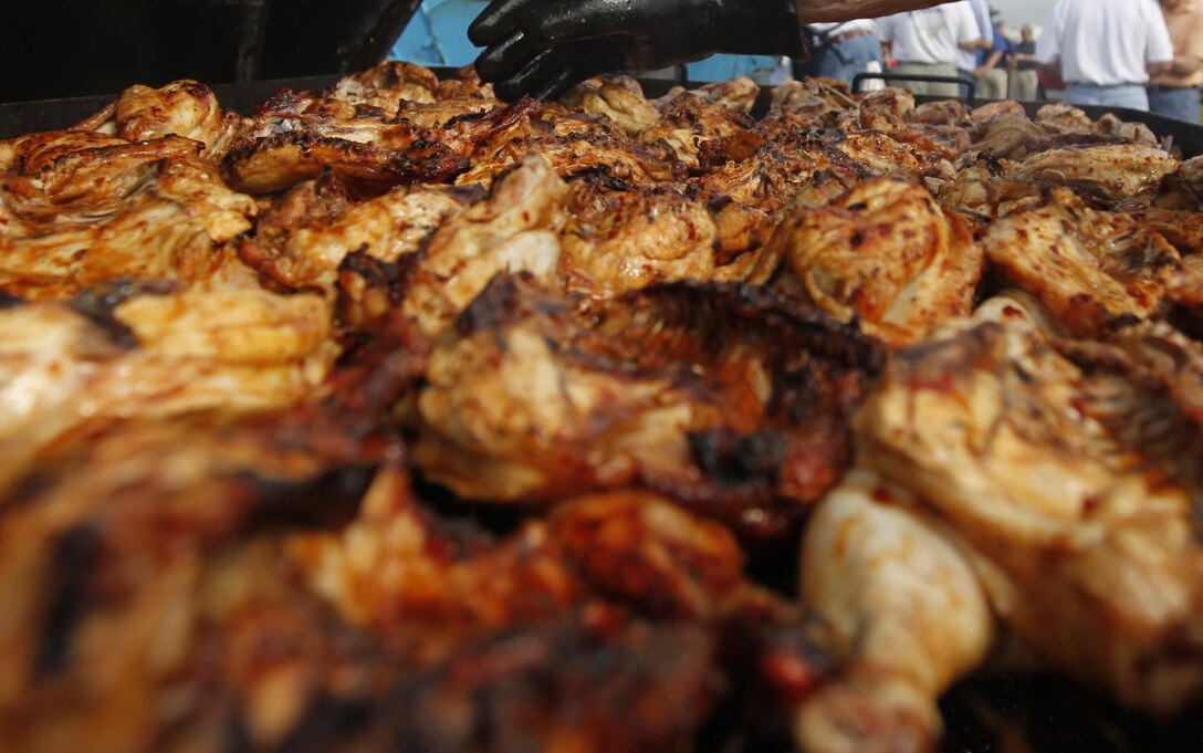 A New Bern Military Alliance Committee member prepares a full grill of chicken for Marines and Sailors during Spring Chicken Pickin' May 2.