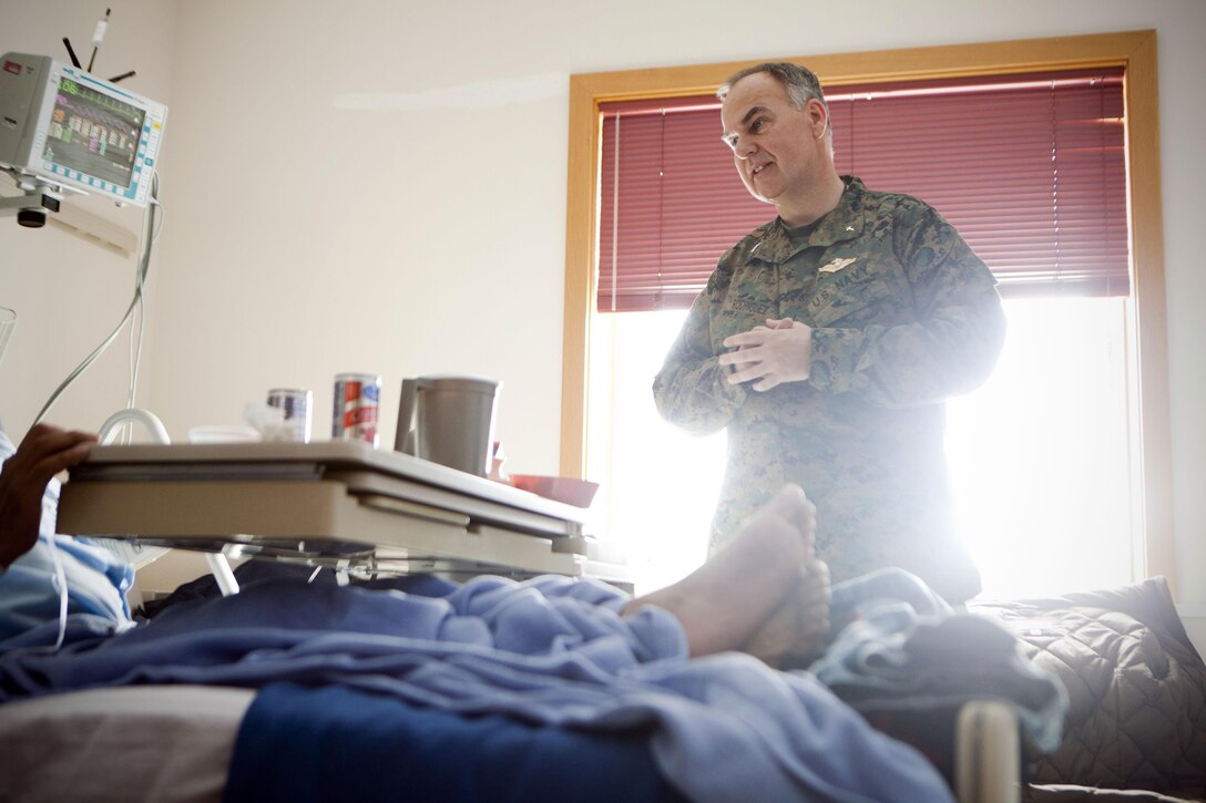 Navy Capt. David Rodriguez, the command chaplain for 4th Marine Logistics Group, Marine Forces Reserve, talks with a patient of Maniilaq Health Center, April 24. Rodriguez made it his routine to check on the patients of the hospital to provide spiritual help. Rodriguez also flew to villages like Point Hope, Alaska, where he provided spiritual guidance to service members who helped save a victim of suicide attempt, as well as his family members and friends. Rodriguez and other service members were part of the Innovative Readiness Training Arctic Care 2013, which is a multi-service humanitarian and training program that focuses on enhancing the capability of U.S. forces in peacetime support operations, humanitarian assistance and disaster relief. IRT Arctic Care brings medical, dental and veterinary aid to 12 rural villages in Alaska. The exercise is primarily a Reserve effort with Marine Forces Reserve taking the lead and receiving logistical and medical support from the National Guard, Army Reserve, Navy Reserve and Air Force Reserve. 