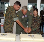 Gen. Ralph “Ed” Eberhart, commander of U.S. Northern Command, Master Gunnery Sgt. Scott Simpson and A1C Robyn Rushing cut the ceremonial cake during the USNORTHCOM’s second anniversary celebration Sept. 30.
