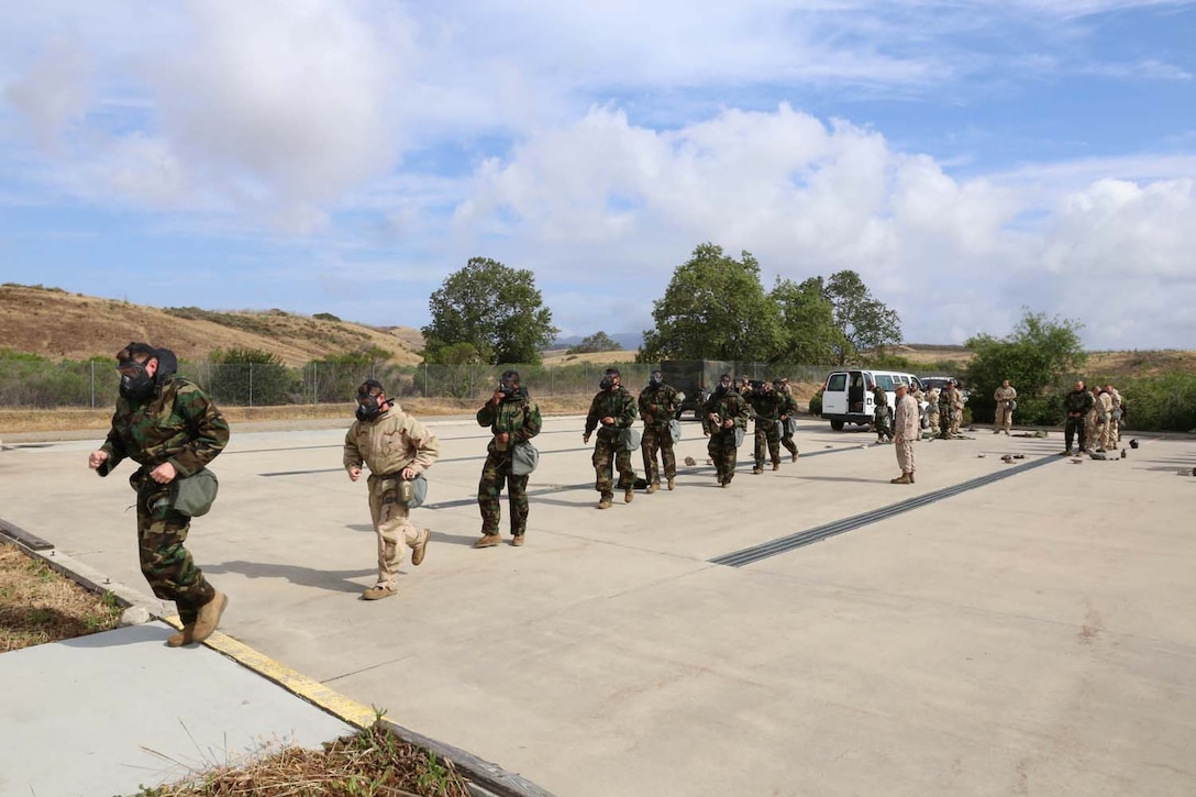 MARINE CORPS BASE CAMP PENDLETON, Calif. – Marines with the 11th Marine Expeditionary Unit run towards the gas chamber as part of annual gas chamber confidence training here May 8. The 11th MEU’s goal is to complete CBRN confidence training every quarter while still completing the annual gas chamber training requirement.   
