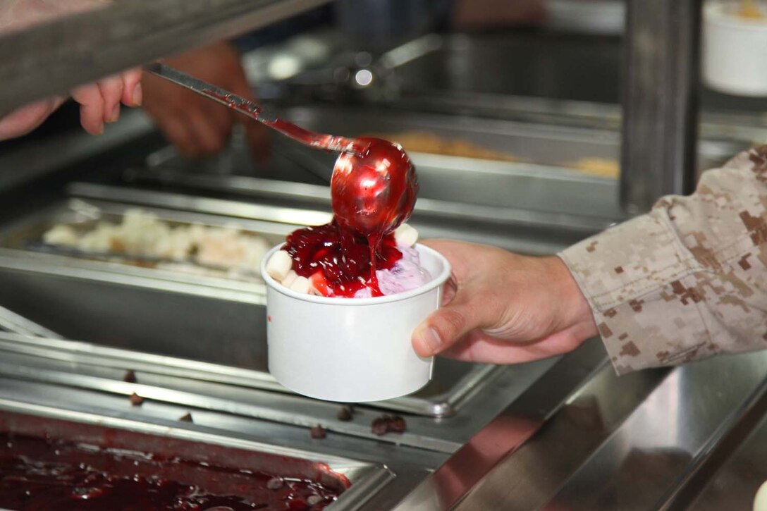 Lance Cpl. Regal Tabtimsri, field wireman, Command Element, 15th Marine Expeditionary Unit, attends an ice cream social on the mess deck aboard USS Peleliu, May 6.  The event is among many planned for the servicemembers and their friends and families during the last leg of their deployment. The 15th MEU is comprised of approximately 2,400 Marines and sailors and is deployed as part of the Peleliu Amphibious Ready Group. Together, they provide a forward-deployed, flexible sea-based Marine Air Ground Task Force capable of conducting a wide variety of operations ranging from humanitarian aid to combat. Tabtimsri, 20, is from Los Angeles. (U.S. Marine Corps photo by Cpl. Timothy Childers/Released)