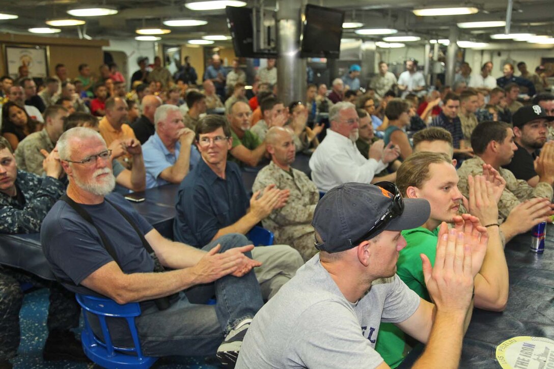 Families and friends of servicemembers attend a welcome aboard presentation during their first day aboard USS Peleliu, May 6. During the last leg of the deployment, families and friends came aboard the ship to experience life on the Peleliu and to learn what their Marine or sailor has accomplished during the past seven months. The 15th MEU is comprised of approximately 2,400 Marines and sailors and is deployed as part of the Peleliu Amphibious Ready Group. Together, they provide a forward-deployed, flexible sea-based Marine Air Ground Task Force capable of conducting a wide variety of operations ranging from humanitarian aid to combat. (U.S. Marine Corps photo by Cpl. Timothy Childers/Released)