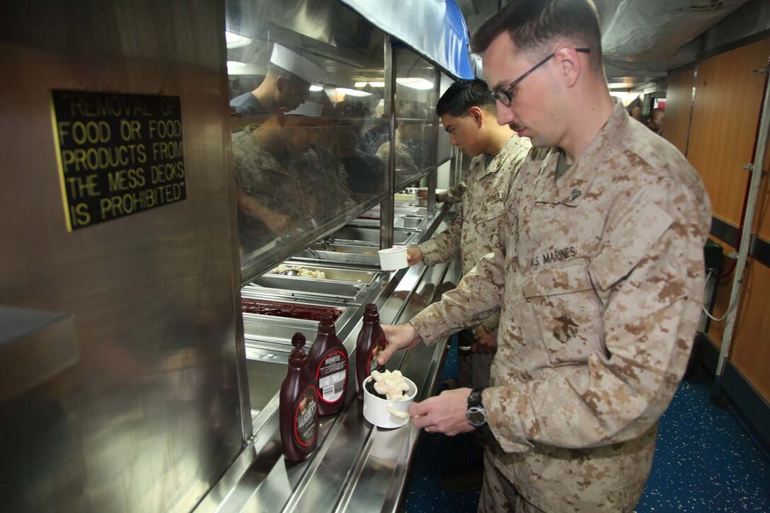 Corporal William A. Rafferty, field radio operator, Battalion Landing Team 3/5, 15th Marine Expeditionary Unit, attends an ice cream social on the mess deck aboard USS Peleliu, May 6.  The event is among many planned for the servicemembers and their friends and families during the last leg of their deployment. The 15th MEU is comprised of approximately 2,400 Marines and sailors and is deployed as part of the Peleliu Amphibious Ready Group. Together, they provide a forward-deployed, flexible sea-based Marine Air Ground Task Force capable of conducting a wide variety of operations ranging from humanitarian aid to combat. Rafferty, 23, is from Arvada, Colo. (U.S. Marine Corps photo by Cpl. Timothy Childers/Released)