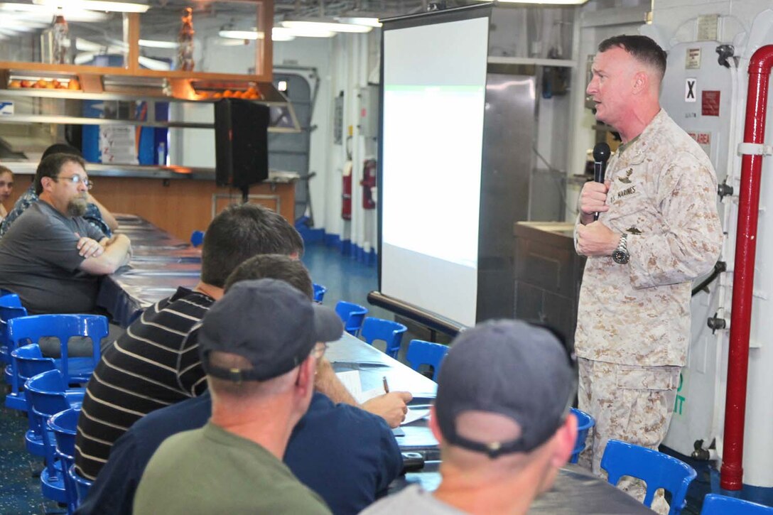 Colonel Scott D. Campbell, commanding officer, 15th Marine Expeditionary Unit, gives a welcome aboard speech to the families and friends of servicemembers aboard USS Peleliu, May 6. During the last leg of the deployment, families and friends came aboard the ship to experience life on the Peleliu and to learn what their Marine or sailor has accomplished during the past seven months. The 15th MEU is comprised of approximately 2,400 Marines and sailors and is deployed as part of the Peleliu Amphibious Ready Group. Together, they provide a forward-deployed, flexible sea-based Marine Air Ground Task Force capable of conducting a wide variety of operations ranging from humanitarian aid to combat. (U.S. Marine Corps photo by Cpl. Timothy Childers/Released)
