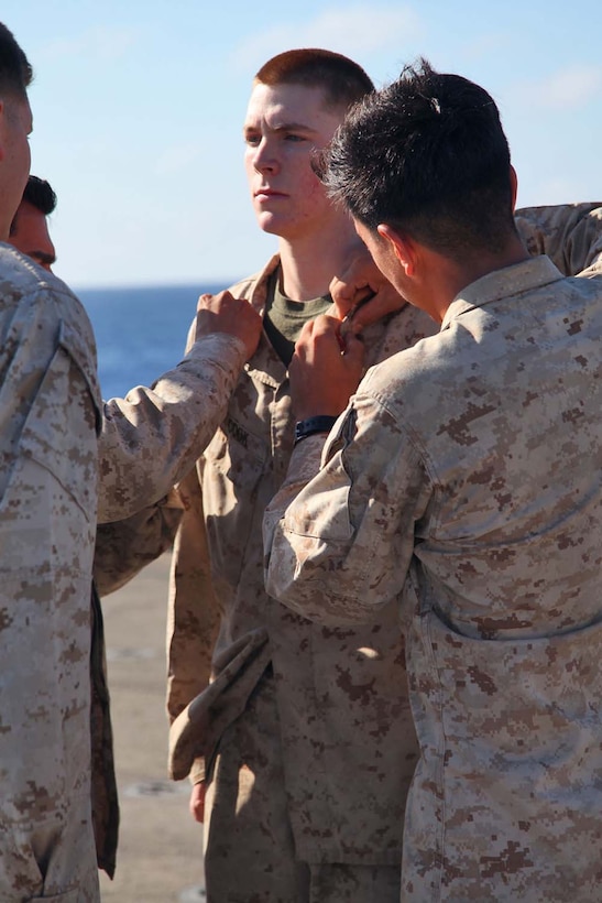 Corporal Jeffrey C. Cook, fire direction controller, 2nd Platoon, Battery B, Battalion Landing Team 3/5, 15th Marine Expeditionary Unit, is promoted to the rank of corporal during a promotion ceremony aboard USS Rushmore, May 1. The 15th MEU is comprised of approximately 2,400 Marines and sailors and is deployed as part of the Peleliu Amphibious Ready Group. Together, they provide a forward-deployed, flexible sea-based Marine Air Ground Task Force capable of conducting a wide variety of operations ranging from humanitarian aid to combat. Cook, 21, is from Orlando, Fl. (U.S. Marine Corps photo by Cpl. Timothy Childers / Released)