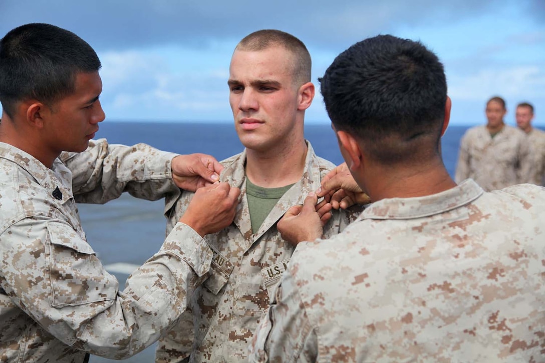 Sergeant Cory R. Nadeau, landing support specialist, Transportation Support Detachment, Combat Logistics Battalion 15, 15th Marine Expeditionary Unit, is promoted to the rank of sergeant during a promotion ceremony aboard USS Rushmore, May 1. The 15th MEU is comprised of approximately 2,400 Marines and sailors and is deployed as part of the Peleliu Amphibious Ready Group. Together, they provide a forward-deployed, flexible sea-based Marine Air Ground Task Force capable of conducting a wide variety of operations ranging from humanitarian aid to combat. Nadeau, 22, is from Wakefield, Mass. (U.S. Marine Corps photo by Cpl. Timothy Childers /Released)