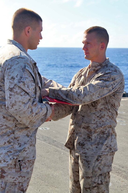 Corporal Brandon L. Fitzgerald, field artillery cannoneer, 1st Platoon, Battery B, Battalion Landing Team 3/5, 15th Marine Expeditionary Unit, is promoted to the rank of corporal during a promotion ceremony aboard USS Rushmore, May 1. The 15th MEU is comprised of approximately 2,400 Marines and sailors and is deployed as part of the Peleliu Amphibious Ready Group. Together, they provide a forward-deployed, flexible sea-based Marine Air Ground Task Force capable of conducting a wide variety of operations ranging from humanitarian aid to combat. Fitzgerald, 24, is from Auroa, Ill. (U.S. Marine Corps photo by Cpl. Timothy Childers / Released)
