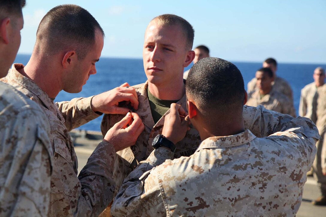 Corporal Brendin A. Stephens, field artillery cannoneer, 2nd Platoon, Battery B, Battalion Landing Team 3/5, 15th Marine Expeditionary Unit, is promoted to the rank of corporal during a promotion ceremony aboard USS Rushmore, May 1. The 15th MEU is comprised of approximately 2,400 Marines and sailors and is deployed as part of the Peleliu Amphibious Ready Group. Together, they provide a forward-deployed, flexible sea-based Marine Air Ground Task Force capable of conducting a wide variety of operations ranging from humanitarian aid to combat. Stephens, 21, is from Cyprus, Texas (U.S. Marine Corps photo by Cpl. Timothy Childers / Released)
