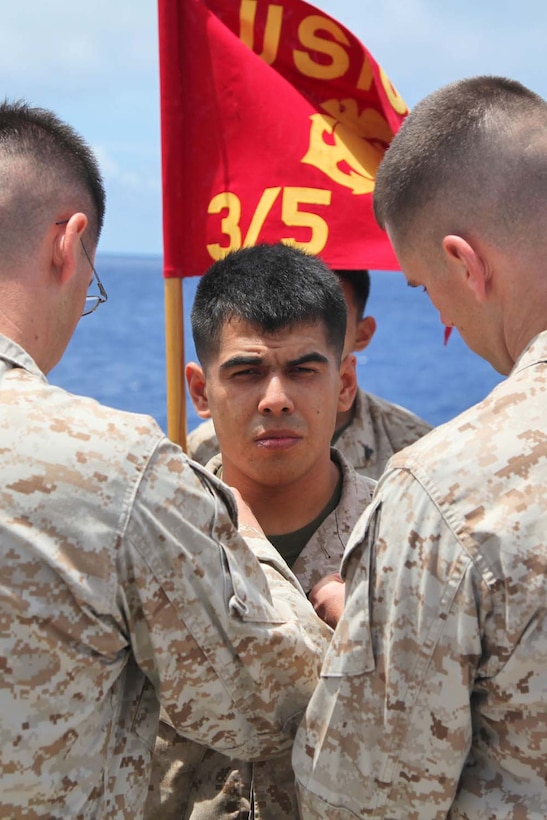 Sergeant Jorge Vicencio, field radio operator, Combined Anti-Armor Team 1, Weapons Company, Battalion Landing Team 3/5, 15th Marine Expeditionary Unit, is promoted to the rank of sergeant during a promotion ceremony aboard USS Rushmore, May 1. The 15th MEU is comprised of approximately 2,400 Marines and sailors and is deployed as part of the Peleliu Amphibious Ready Group. Together, they provide a forward-deployed, flexible sea-based Marine Air Ground Task Force capable of conducting a wide variety of operations ranging from humanitarian aid to combat. Vicencio, 25, is from Farmersville, Calif. (U.S. Marine Corps photo by Cpl. Timothy Childers / Released)