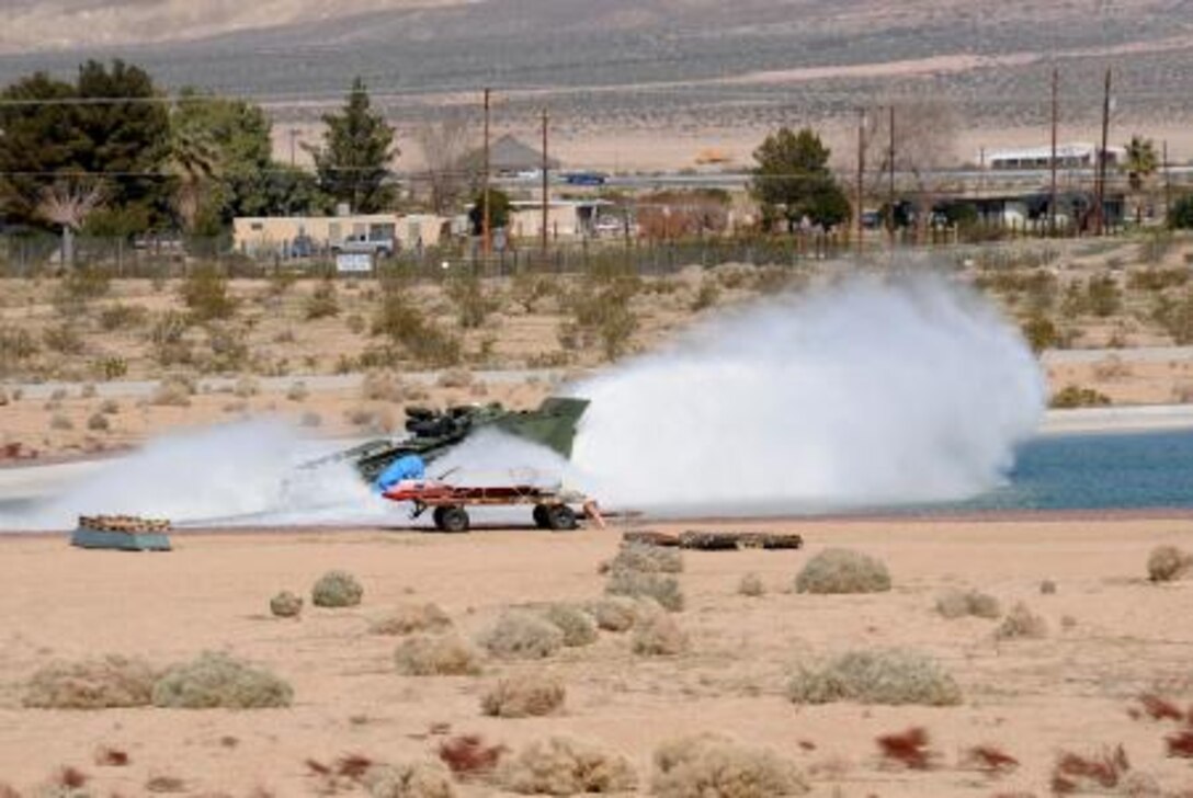 An amphibious assault vehicle plunges into the water portion of the Marine Corps' largest test track at Production Plant Barstow, Marine Depot Maintenance Command on Marine Corps Logistics Base Barstow. Vehicles are tested daily on the track to check their readiness.


