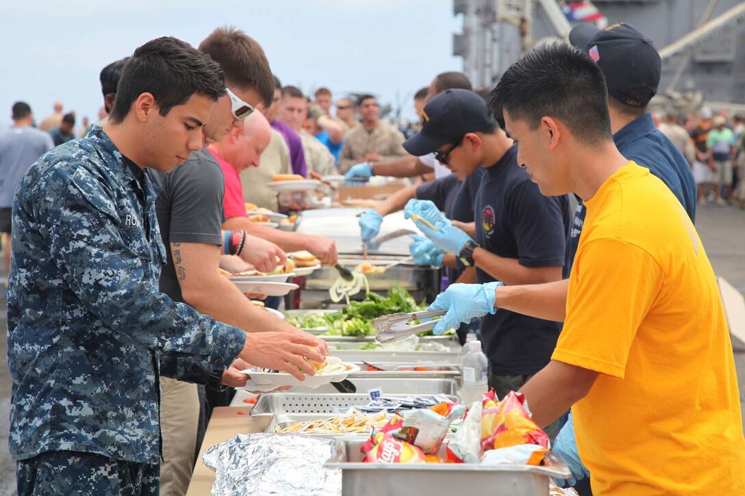 Servicemembers, their families and friends attend a steel beach picnic aboard USS Peleliu, May 8. During the last leg of the deployment, families and friends came aboard the ship to experience life on the Peleliu and to learn what their Marine or sailor has accomplished during the past seven months. The 15th MEU is comprised of approximately 2,400 Marines and sailors and is deployed as part of the Peleliu Amphibious Ready Group. Together, they provide a forward-deployed, flexible sea-based Marine Air Ground Task Force capable of conducting a wide variety of operations ranging from humanitarian aid to combat. (U.S. Marine Corps photo by Cpl. Timothy Childers / Released)
