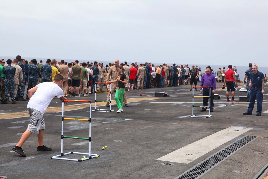 Servicemembers, their families and friends attend a steel beach picnic aboard USS Peleliu, May 8. During the last leg of the deployment, families and friends came aboard the ship to experience life on the Peleliu and to learn what their Marine or sailor has accomplished during the past seven months. The 15th MEU is comprised of approximately 2,400 Marines and sailors and is deployed as part of the Peleliu Amphibious Ready Group. Together, they provide a forward-deployed, flexible sea-based Marine Air Ground Task Force capable of conducting a wide variety of operations ranging from humanitarian aid to combat. (U.S. Marine Corps photo by Cpl. Timothy Childers / Released)