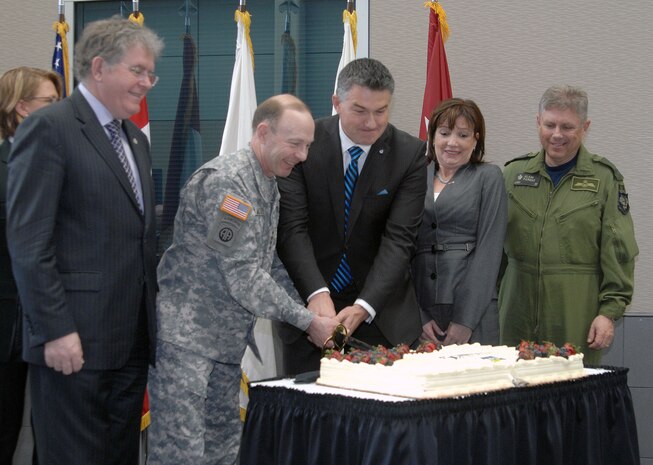 PETERSON AIR FORCE BASE, Colo. - North American Aerospace Defense Command leadership and members of the Canadian government cut the NORAD 55th anniversary cake during a ceremony at the command's headquarters here May 9, 2013. From left to right: Jack Harris, vice chair of the Canadian Standing Committee on National Defence; Army Gen. Chuck Jacoby, commander of NORAD and U.S. Northern Command; James Bezan, Chairman of the NDDN; Marcy Grossman, Consul General of Canada in Denver; and Canadian Lt.-Gen. Alain Parent, deputy commander of NORAD. 