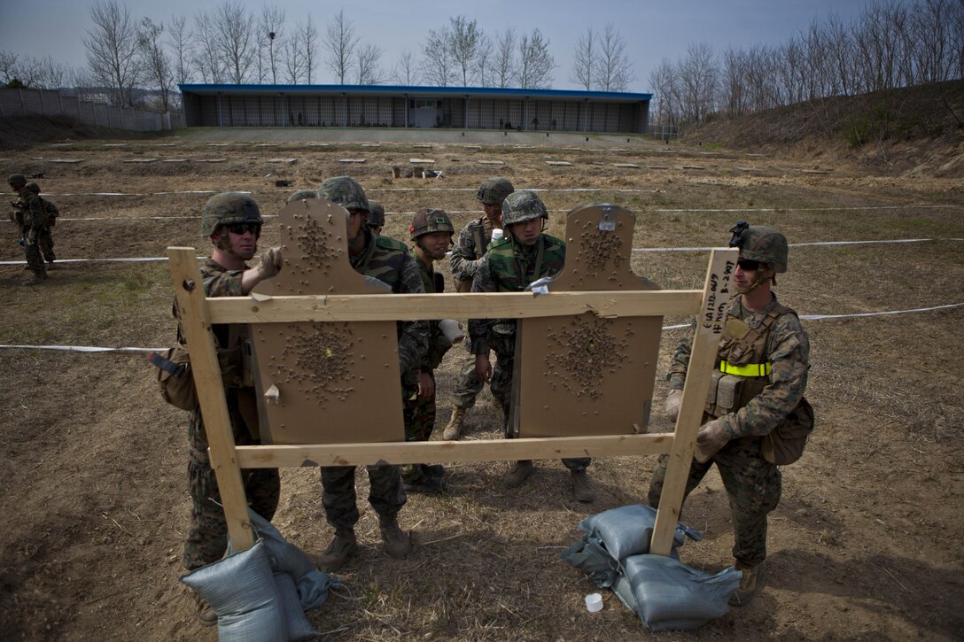 U.S. Marines with Charlie Company, Battalion Landing Team 1st Battalion, 5th Marines, 31st Marine Expeditionary Unit and Republic of Korea Marines add up qualification scores while participating in Combat Marksmanship Program during the Korean Marine Exchange Program (KMEP) in Su Sung Ri, Republic of  Korea, April 4, 2013. KMEP is a bilateral training exercise conducted in the Republic of Korea to enhance the readiness of both militaries and strengthen interoperability between the U.S. and Republic of Korea governments.