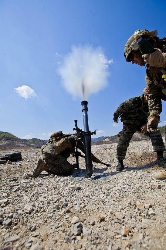 U.S. Marines with Weapons Company, Battalion Landing Team 1st Battalion, 5th Marines, 31st Marine Expeditionary Unit, fire 81 millimeter mortar rounds during the Korean Marine Exchange Program (KMEP) at the Combined Arms Training Center, Su Sung Ri, Republic of Korea, April 10, 2013. KMEP is a bilateral training exercise conducted in the Republic of Korea to enhance the readiness of both militaries and strengthen interoperability between the U.S. and Republic of Korea governments.