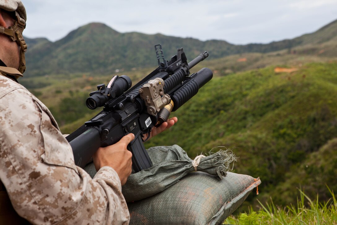 Lance Cpl. Devon T. Voorhees loads an M203 grenade launcher during weapons systems familiarization and fire-and-maneuver exercises at Range 2 on Camp Hansen April 29. Marines also fired the M203 grenade launcher, AT-4 light anti-armor weapon and the MK153 shoulder-fired multipurpose assault weapon to increase proficiency. Following the weapons systems familiarization training, Marines conducted fire-and-maneuver rehearsals. Voorhees is a rifleman with 3rd Battalion, 6th Marine Regiment, which is currently assigned to 4th Marine Regiment, 3rd Marine Division, III Marine Expeditionary Force, under the unit deployment program. (U.S. Marine Corps photo by Pfc. Kasey Peacock/Released)