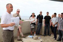 Marines stand atop Kakazu Ridge as Capt. Brad A. Danks, left, discusses how U.S. intelligence gathering affected the Battle of Okinawa as part of a battle sites tour April 29 near Urasoe City. The tour is provided every three months to Marines with 3rd Marine Logistics Group, III Marine Expeditionary Force, so they better understand the battle and conditions Japan and U.S. service members endured. Danks is the deputy chief of staff, G-2, intelligence and security, 3rd MLG Headquarters, 3rd MLG, III Marine Expeditionary Force.
