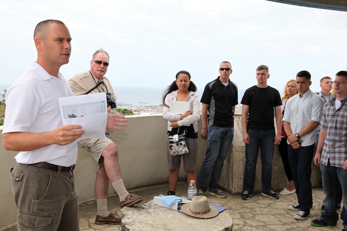 Marines stand atop Kakazu Ridge as Capt. Brad A. Danks, left, discusses how U.S. intelligence gathering affected the Battle of Okinawa as part of a battle sites tour April 29 near Urasoe City. The tour is provided every three months to Marines with 3rd Marine Logistics Group, III Marine Expeditionary Force, so they better understand the battle and conditions Japan and U.S. service members endured. Danks is the deputy chief of staff, G-2, intelligence and security, 3rd MLG Headquarters, 3rd MLG, III Marine Expeditionary Force.