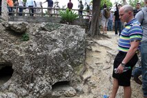 Sgt. Robert J. Novotny looks at the remains of a fortified Japanese pillbox from World War II during a Battle of Okinawa tour April 29 near Urasoe City. Marines with 3rd Marine Logistics Group are given the tour quarterly to help them understand their heritage and remember the sacrifices of Japan and U.S. service members and civilians who perished during the battle. Novotny is a financial management resource analyst with 3rd MLG Headquarters, 3rd MLG, III Marine Expeditionary Force.
