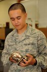 U.S. Air Force Airman 1st Class Matthew Rodriguez, 18th Civil Engineer Squadron pest management apprentice, holds a Ball Python on Kadena Air Base, Japan, May 7, 2013. The 18th CES Pest Management flight is the largest in Pacific Air Forces and handles pest control within all Department of Defense housing units. Their personnel travel to places like Okuma, White Beach, Camp Hansen and other bases across Okinawa in support of the mission. (U.S. Air Force photo by Airman 1st Class Hailey R. Davis/Released)