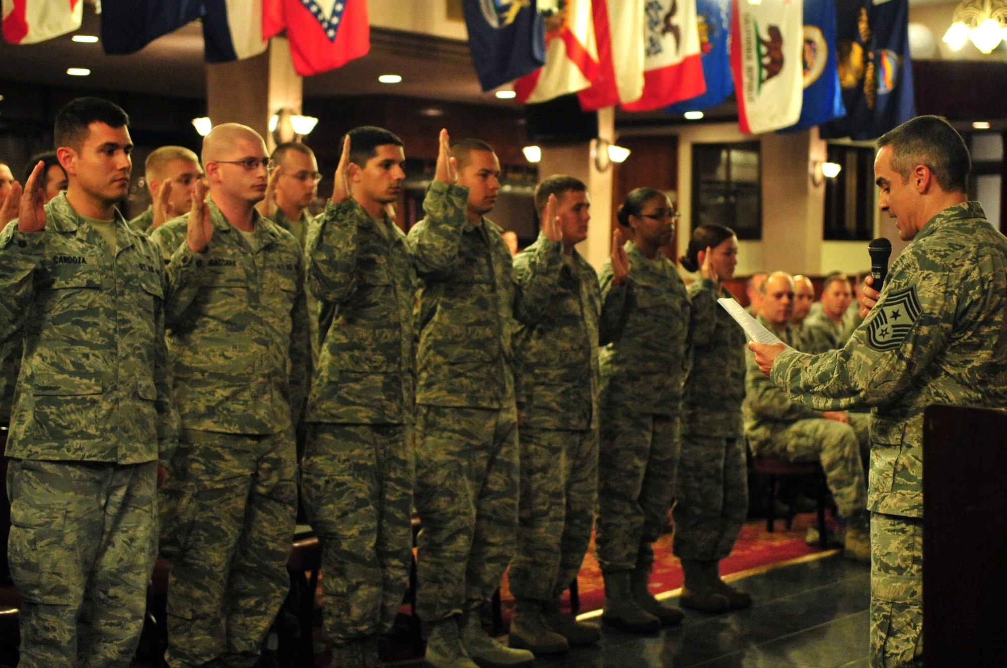 U.S. Air Force Chief Master Sgt. Ramon Colon-Lopez, 18th Wing command chief, inducts newly promoted staff sergeants during a quarterly NCO Induction ceremony on Kadena Air Base, Japan, May 8, 2013. The ceremony celebrates those who have put on the rank of staff sergeant and have reached NCO status. (U.S. Air Force photo by Senior Airman Amber E. N. Jacobs/Released)