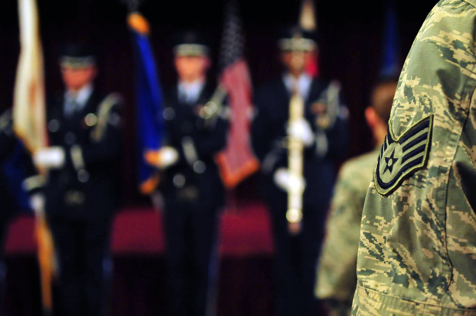 U.S. Air Force staff sergeants honor the colors during a quarterly NCO Induction ceremony on Kadena Air Base, Japan, May 8, 2013. The ceremony recognized those who have recently put on the rank of staff sergeant and have reached NCO status. (U.S. Air Force photo by Senior Airman Amber E. N. Jacobs/Released)