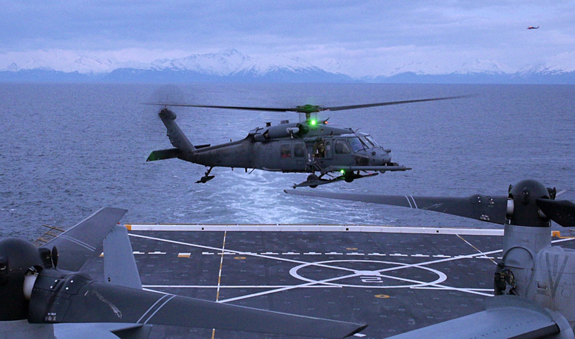 An Alaska Air National Guard HH-60 Pave Hawk combat search and rescue helicopter, from the 210th Rescue Squadron, prepares to land on the flight deck of the USS Anchorage, an amphibious landing craft, on Cook Inlet April 30, 2013. The Pave Hawk pilots practiced landing on the USS Anchorage to receive training not readily available in the region. The USS Anchorage came to the Port of Anchorage for a commissioning ceremony in the city it was named after. (U.S. Air Force photo/Staff Sgt. Zachary Wolf)