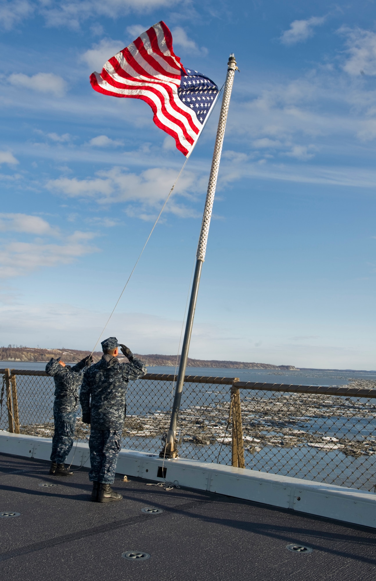 Sailors assigned to the USS Anchorage, an amphibious landing craft, raise the U.S. flag after pulling into the Port of Anchorage, May 1, 2013. The USS Anchorage came to the Port of Anchorage for a commissioning ceremony in the city it was named after. (U.S. Air Force photo/Staff Sgt. Zachary Wolf)